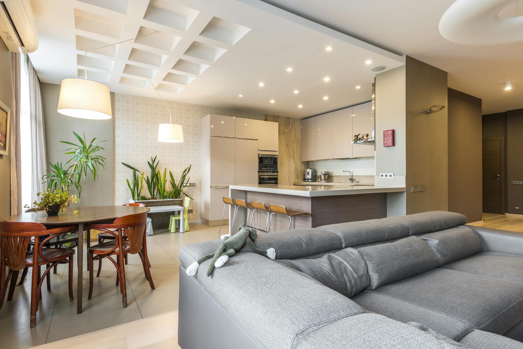 Bright modern apartment interior featuring stylish furniture and vibrant plants, perfect for contemporary living.